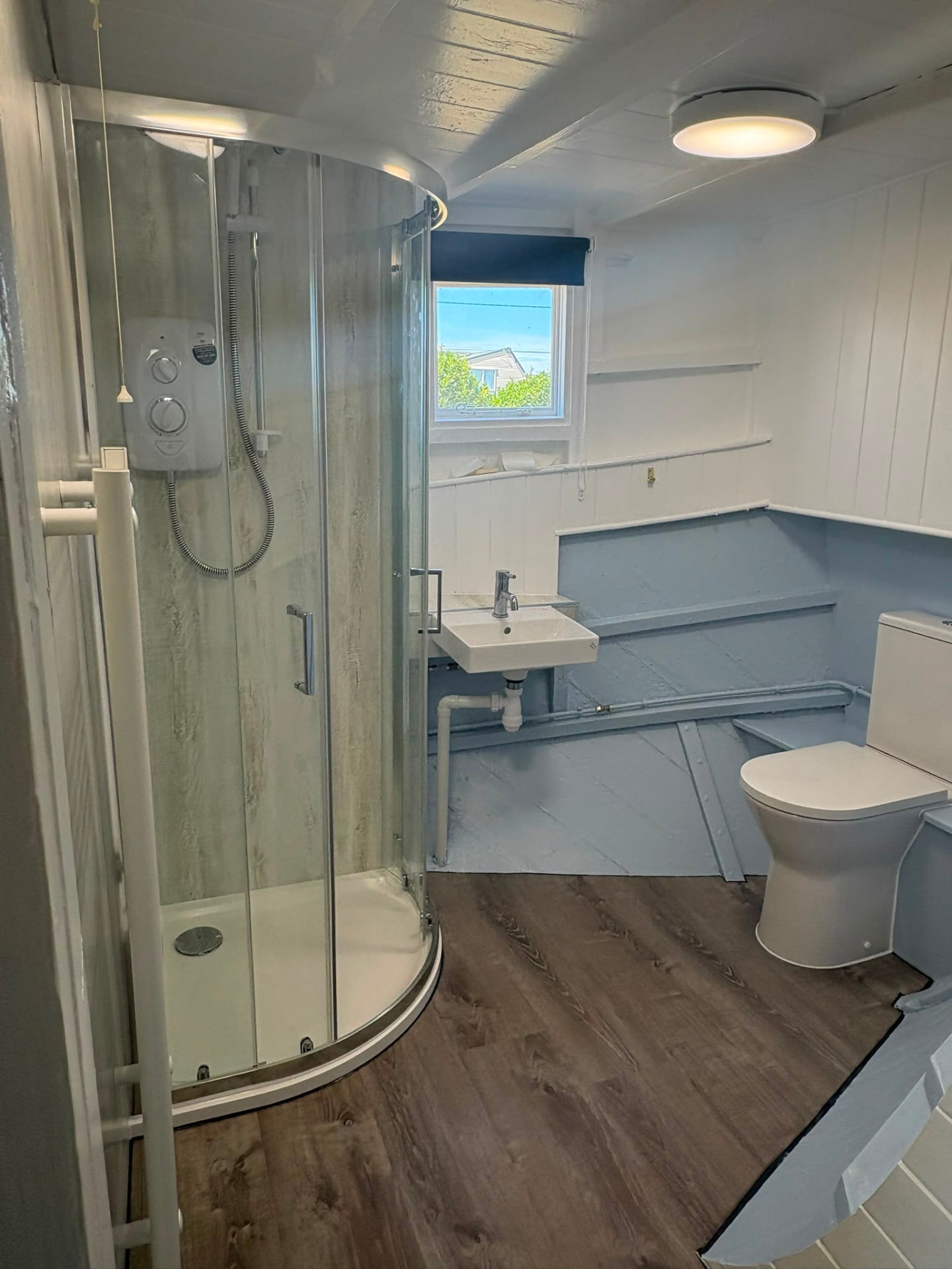 Compact shower room with quadrant enclosure and new flooring
